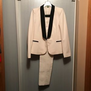 Elegant cream suit with black trim.